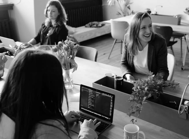 Image of people working on a desk